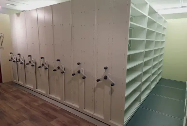 Newly installed mobile shelving system with seven mobile bases in smoke white finish.
